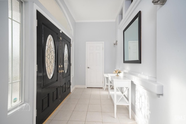 foyer with plenty of natural light, crown molding, and light tile patterned flooring