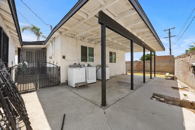 2110 Center St, Bakersfield, CA 93305 - fenced backyard featuring separate washer and dryer, a patio area, and a gate