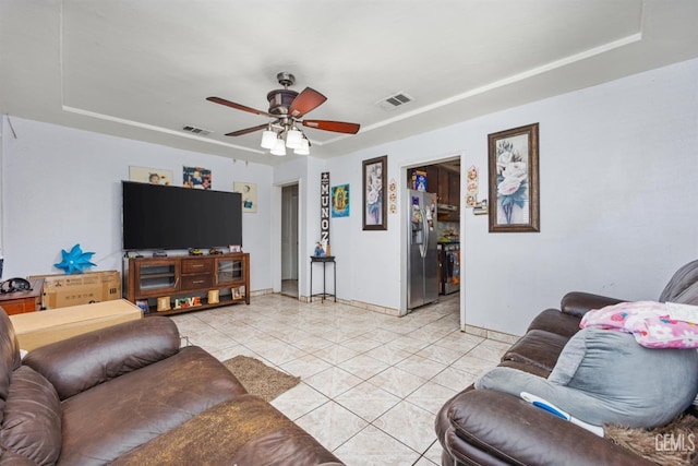 2110 Center St, Bakersfield, CA 93305 - living area with light tile patterned flooring, a ceiling fan, and a raised ceiling