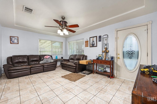 2110 Center St, Bakersfield, CA 93305 - living room with a tray ceiling, ceiling fan, and light tile patterned floors