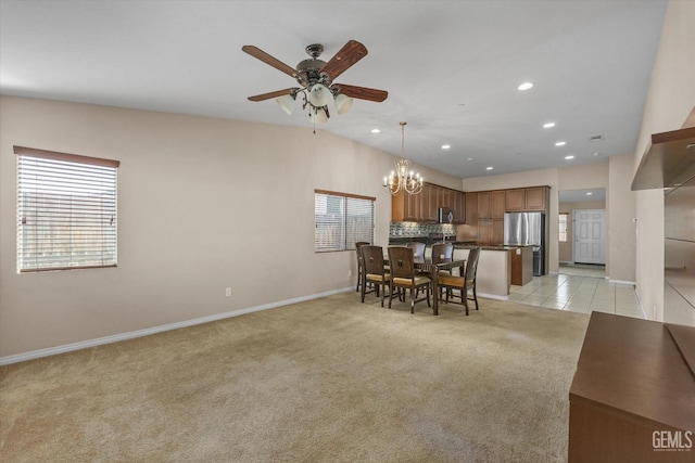 dining area featuring light carpet, a healthy amount of sunlight, light tile patterned floors, and recessed lighting