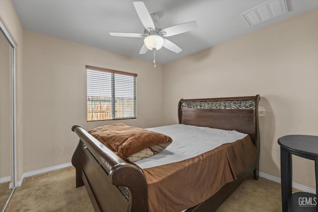 bedroom with baseboards, visible vents, a closet, and light colored carpet