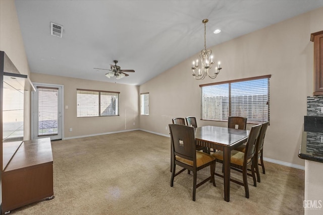 dining area featuring light carpet, baseboards, visible vents, and lofted ceiling