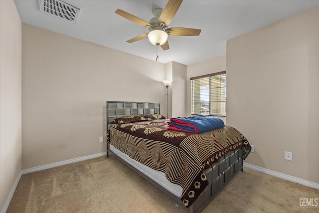 bedroom featuring baseboards, a ceiling fan, visible vents, and light colored carpet