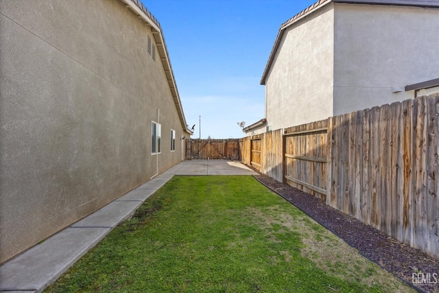 view of yard featuring a patio area and a fenced backyard