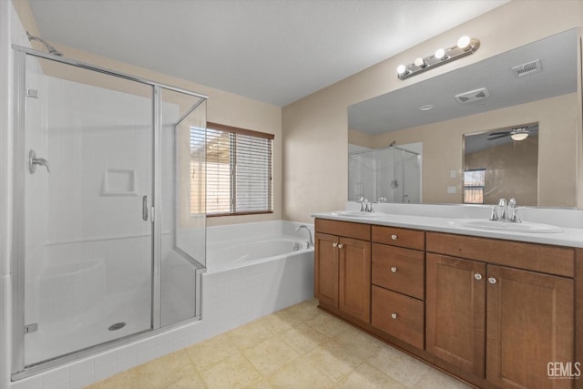 full bath featuring visible vents, a sink, and a garden tub