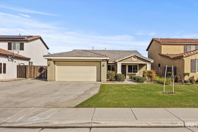 mediterranean / spanish house with stucco siding, an attached garage, a front yard, fence, and driveway