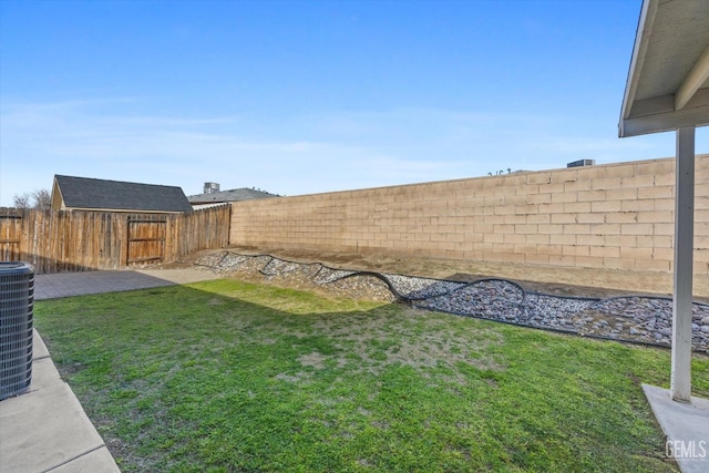 view of yard featuring central AC unit and a fenced backyard