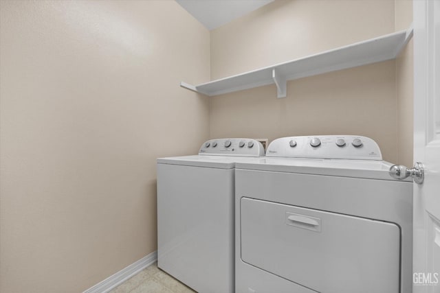 laundry room featuring laundry area, washer and clothes dryer, and baseboards