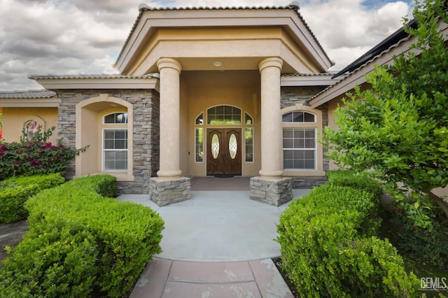 1705 Briercliff Ct, Bakersfield, CA 93311 - doorway to property featuring stone siding, stucco siding, and a porch