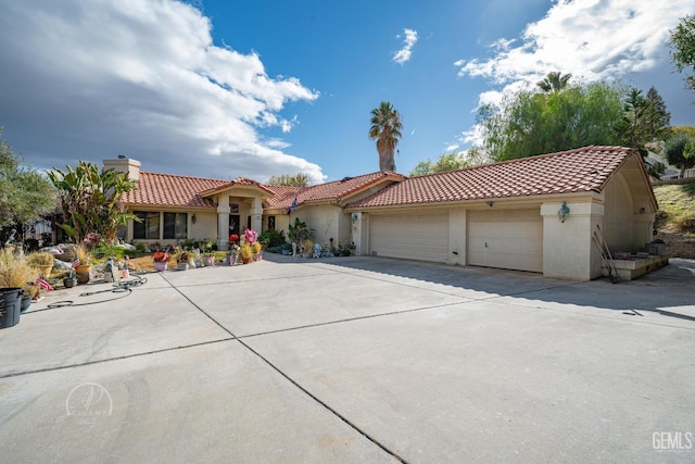 mediterranean / spanish-style house with a garage