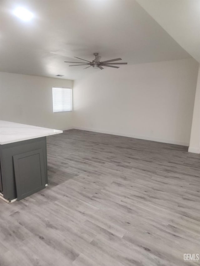 additional living space featuring ceiling fan and light hardwood / wood-style flooring