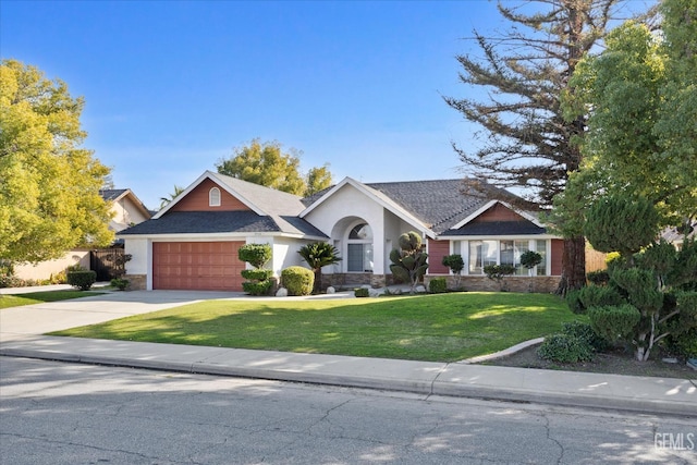 view of front of property featuring a garage and a front yard