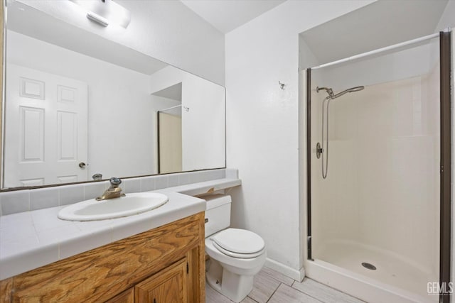 bathroom with vanity, toilet, and walk in shower