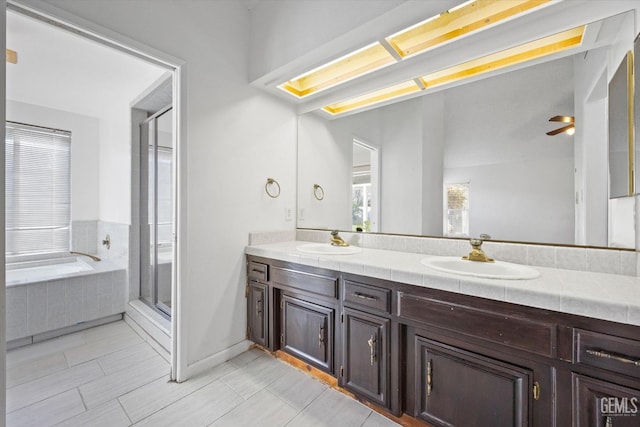 bathroom featuring plus walk in shower, vanity, tile patterned floors, and ceiling fan