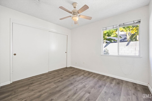 unfurnished bedroom featuring hardwood / wood-style floors, a textured ceiling, a closet, and ceiling fan