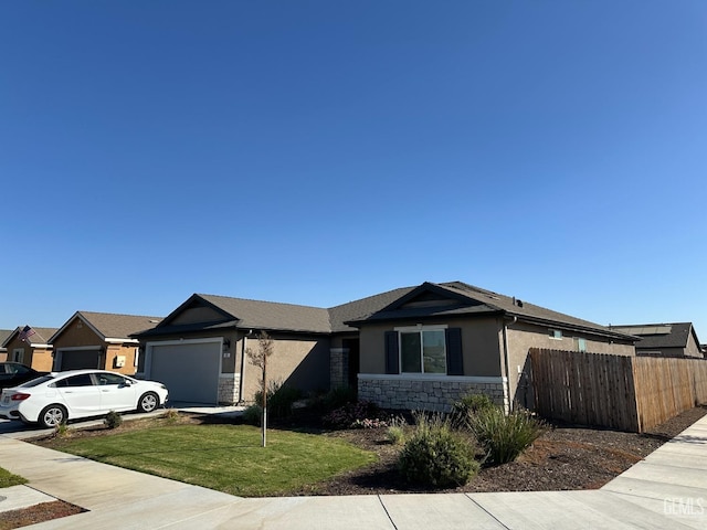 ranch-style house featuring a garage and a front lawn