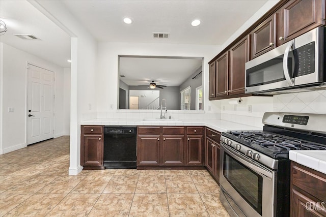 kitchen with a ceiling fan, visible vents, appliances with stainless steel finishes, and a sink