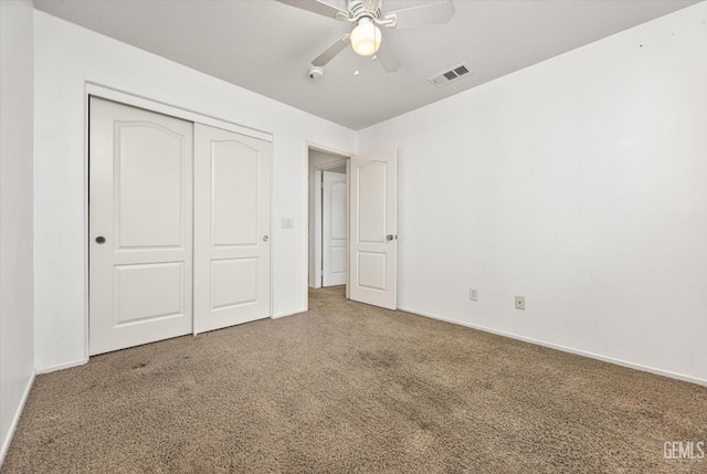 unfurnished bedroom with visible vents, baseboards, carpet, a closet, and a ceiling fan