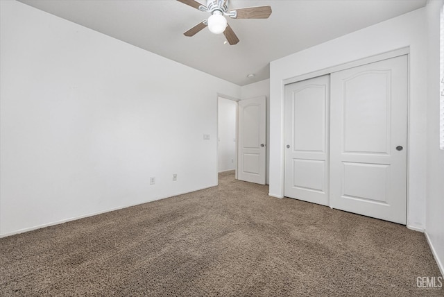 unfurnished bedroom featuring a closet, carpet, and ceiling fan