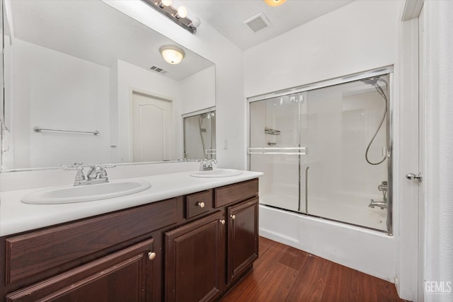 full bath with visible vents, wood finished floors, and a sink