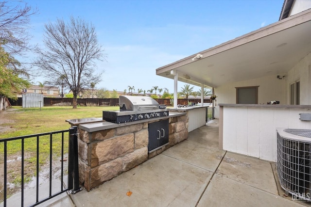 view of patio featuring central air condition unit, area for grilling, a fenced backyard, and grilling area