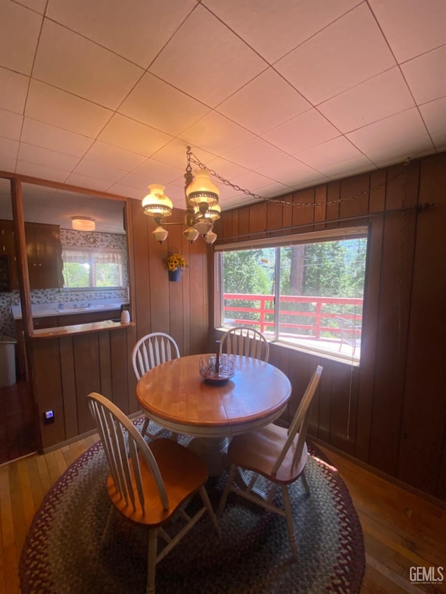 45904 Carlin Dr, Posey, CA 93260 - dining space with hardwood / wood-style flooring, a chandelier, and wood walls