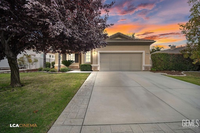 view of front facade with a yard and a garage