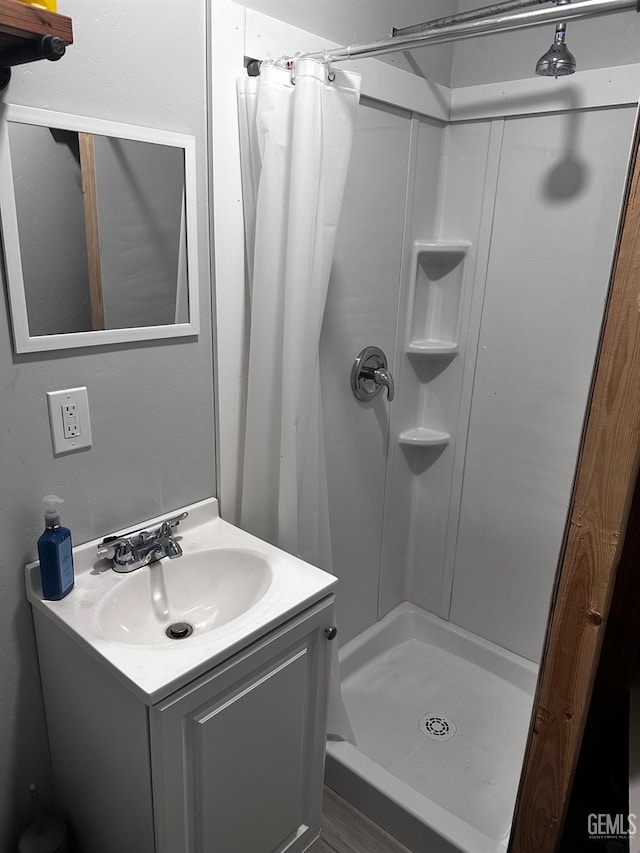 bathroom with vanity and walk in shower