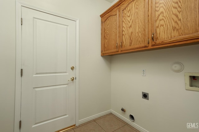 clothes washing area with washer hookup, cabinet space, light tile patterned floors, baseboards, and hookup for an electric dryer