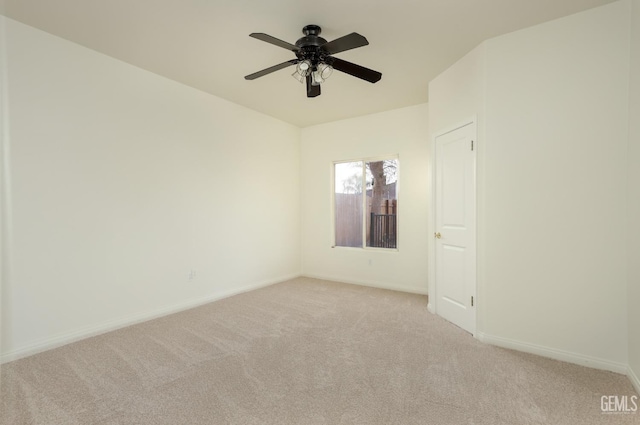 unfurnished room with baseboards, light colored carpet, and ceiling fan