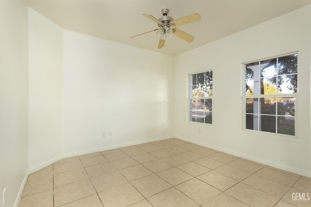 spare room with baseboards and ceiling fan