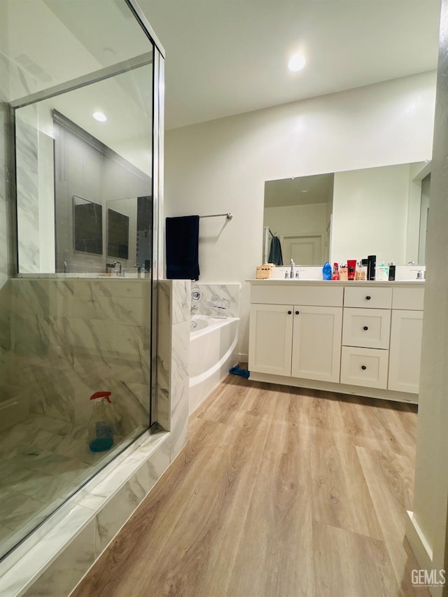 8410 Avon St, Bakersfield, CA 93314 - full bath featuring a garden tub, vanity, a marble finish shower, wood finished floors, and recessed lighting