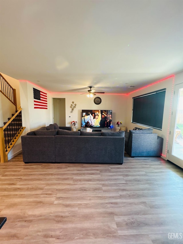 8410 Avon St, Bakersfield, CA 93314 - living area featuring a ceiling fan, stairs, and light wood-style floors