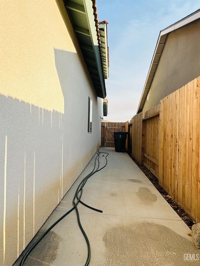 8410 Avon St, Bakersfield, CA 93314 - view of side of home with stucco siding and a patio area
