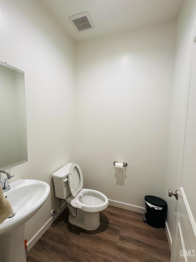 8410 Avon St, Bakersfield, CA 93314 - half bath with toilet and wood finished floors