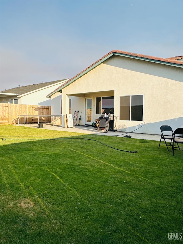 8410 Avon St, Bakersfield, CA 93314 - rear view of house featuring stucco siding and a patio area