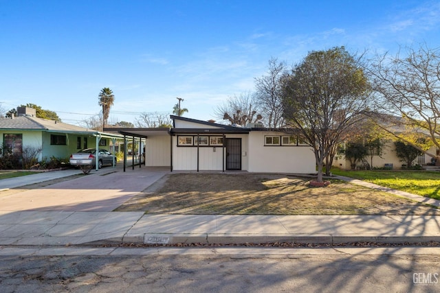 ranch-style home featuring a carport