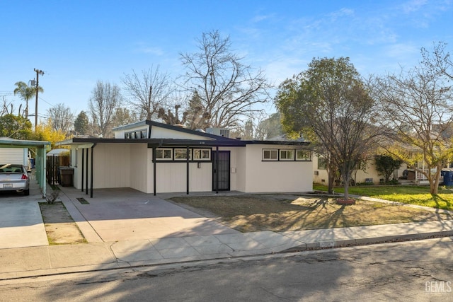 ranch-style house featuring a carport