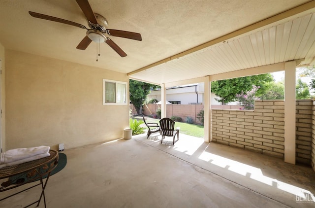 view of patio / terrace featuring fence and ceiling fan