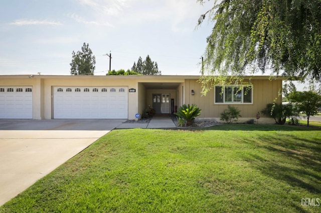 ranch-style home with an attached garage, concrete driveway, and a front yard