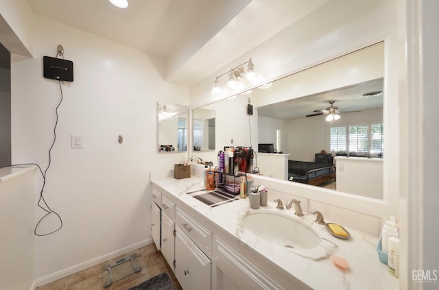 bathroom featuring a ceiling fan, vanity, and baseboards