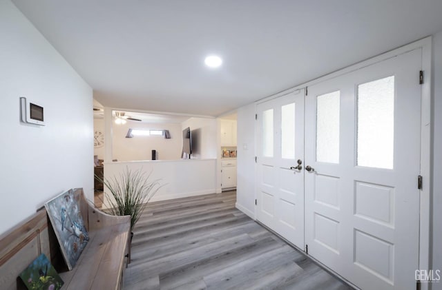 entryway featuring baseboards and light wood finished floors