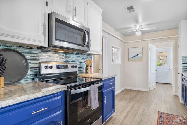 2702 Worthington Ave, Bakersfield, CA 93308 - kitchen with blue cabinets, appliances with stainless steel finishes, decorative backsplash, and white cabinets
