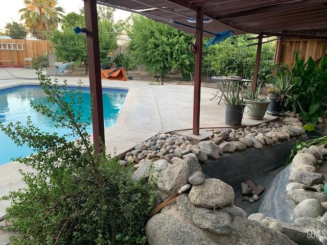 view of pool with a pergola and a patio