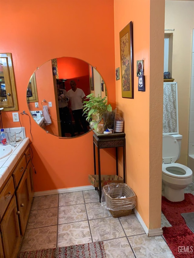 bathroom with tile patterned floors, vanity, and toilet