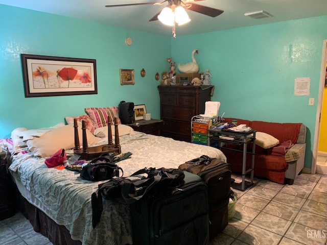 tiled bedroom featuring ceiling fan