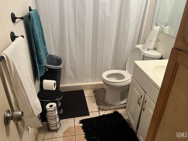 bathroom with toilet, tile patterned flooring, and vanity