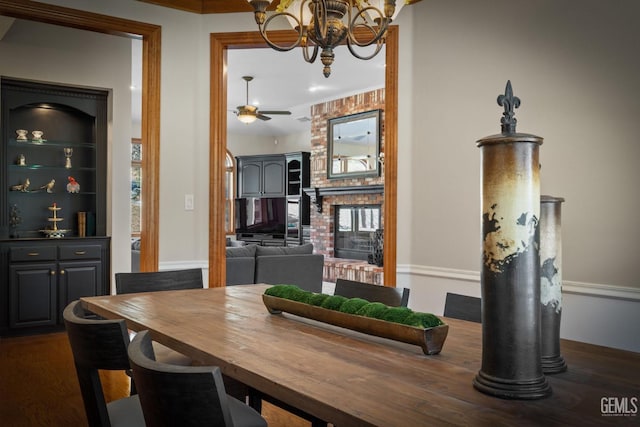 dining room with dark hardwood / wood-style floors and ceiling fan with notable chandelier