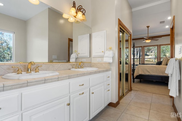 bathroom with tile patterned flooring, vanity, ceiling fan, and crown molding